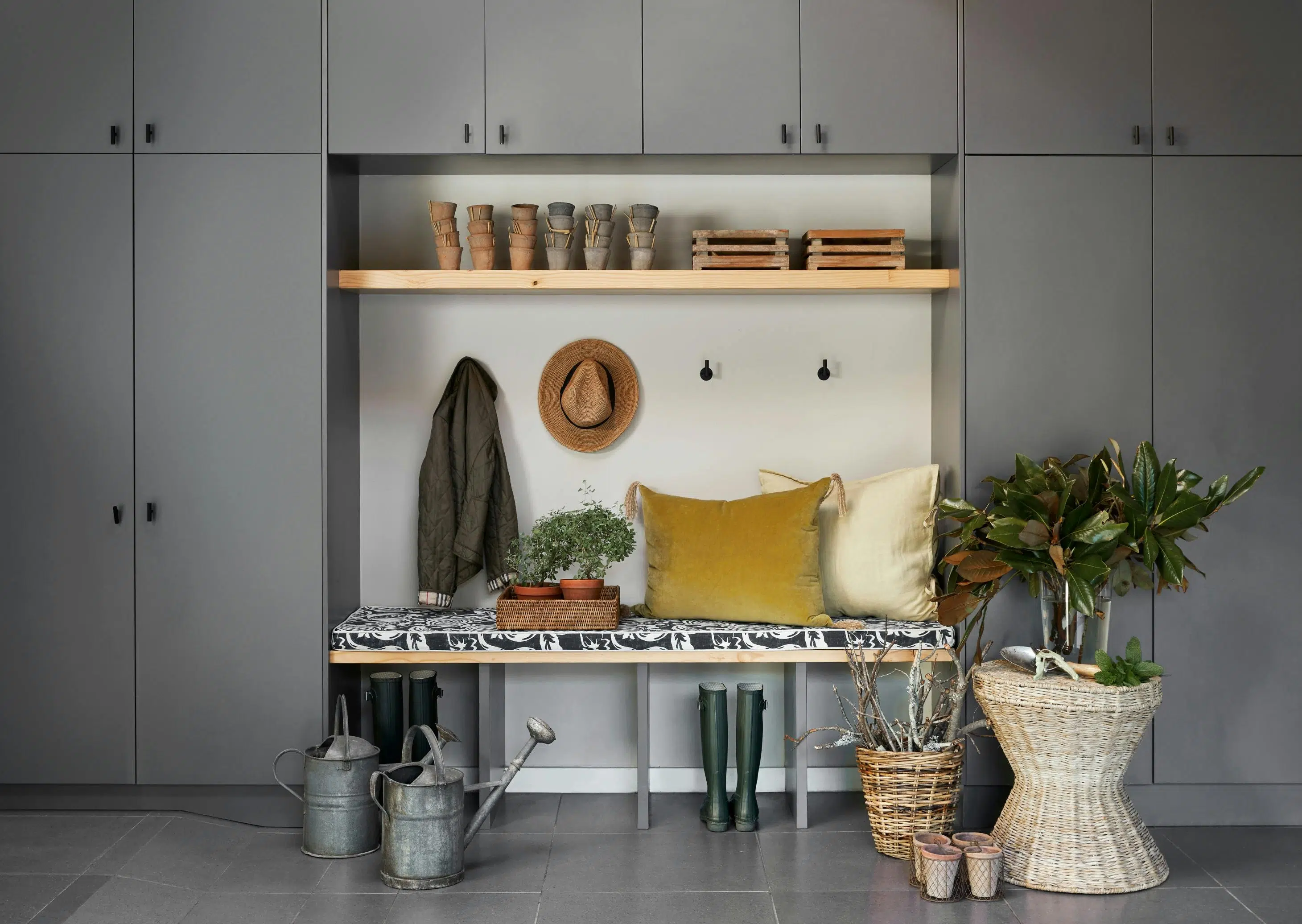 Surrounded by ample bedroom closet doors is a bench with cushions and other bohemian decorative accents.